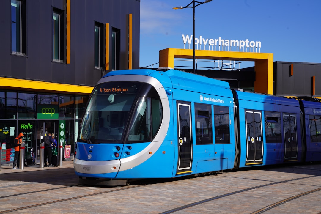 City Centre, Wolverhampton: a blue and white train parked in front of a building